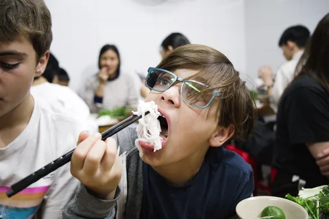 Eating noodles in Hanoi