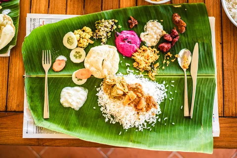 Banana leaf with bright curries, curds and chutneys