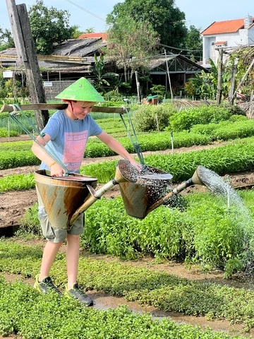 Child trying farming in Hoi An