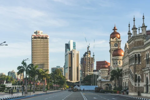 Independence Square, with the historic Sultan Abdul Samad Building on the right and new construction on a tower block on the left