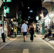 Couples walking through Asia market