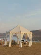 A tent with a dinner table set up by the water on a private safari experience in India in November