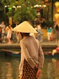 Local Vietnamese woman looking over the lantern lit river in Hoi An 