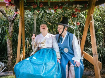 A couple of tourists dressed in traditional South Korean hanbok during a photoshoot 