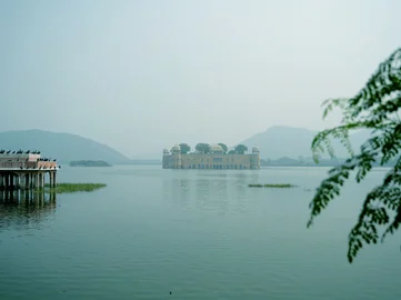 The view across the water in Jaipur of a temple in the background