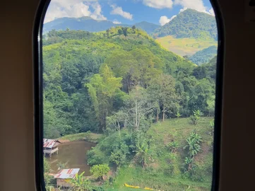 A view from a train window of Laos countryside on a Laos by Rail itinerary