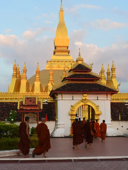 Monks arriving to a temple in February Laos