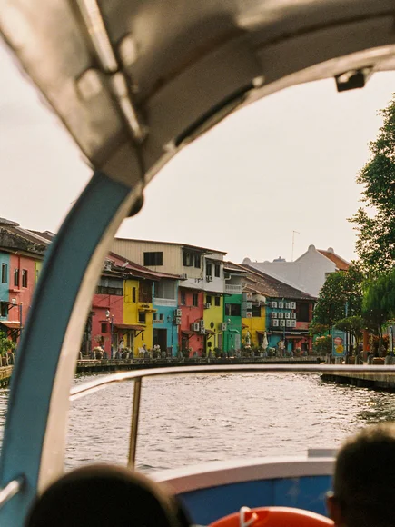 The view of colourful houses from a riverboat cruise in Malaysia on the river