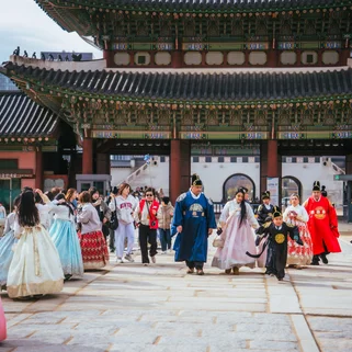Seoul palace in November with people wearing traditional hanbok 