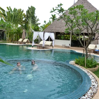 Two kids in a pool on a family holiday to Southeast Asia