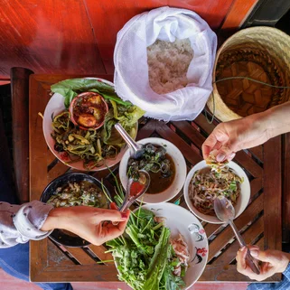 Aerial shot of diners eating traditional Thai food 