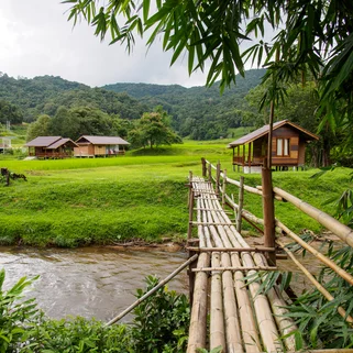 A bamboo bridge over a river in Chiang Mai during July green season