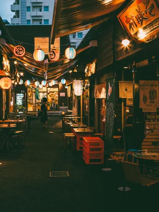 Japanese food stalls and outdoor seating at night 