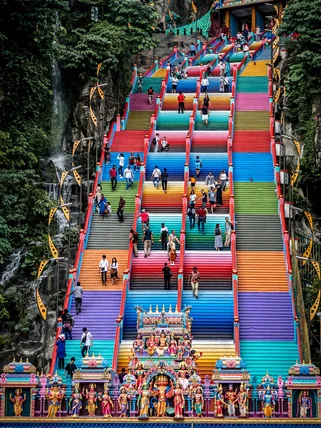 Tourists at the colourful steps of Batu Caves in Malaysia