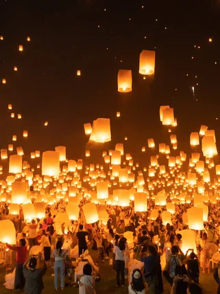 Thai people release sky floating lanterns or lamp to worship Buddha's relics at night. Traditional festival in Chiang mai, Thailand. Loy krathong and Yi Peng Lanna ceremony.