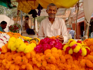 A friendly man in Jaipur at a marigold store in October