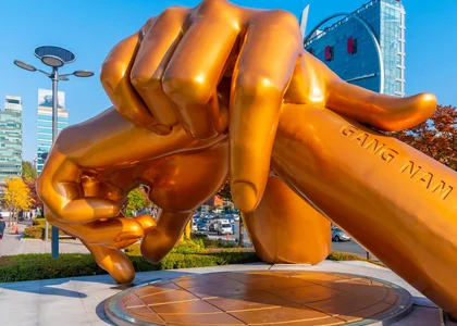 Sculpture of golden hands resting on each other as a Gangnam Style monument in Seoul 