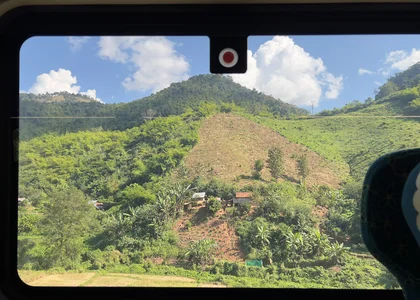 A view from a train window of Laos countryside on a Laos by Rail itinerary
