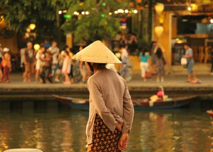 Local Vietnamese woman looking over the lantern lit river in Hoi An 