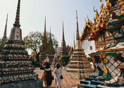Two women walking through the grounds of Wat Pho temple