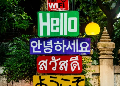 A sign showing the word hello in 4 different languages (English, Korean, Thai, Japanese)