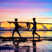 Carrying in the fishing nets at sunset