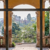 An old brick archway partially painted provides beautiful views of royal palance in Phnom Penh