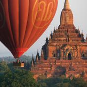 View of a hot air balloon above pagodas of Bagan
