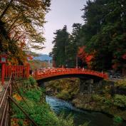 Ornate red bridge over river in Nikko
