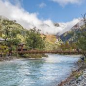 Bridge over fast flowing river in Kamikochi