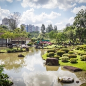 Red bridge over ornamental lake in Chinese and Japanese Gardens in Singapore