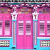 Bright pink doors and colourful trim on Peranakan building in Singapore