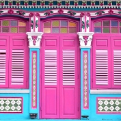 Bright pink doors and colourful trim on Peranakan building in Singapore