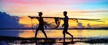 Carrying in the fishing nets at sunset 