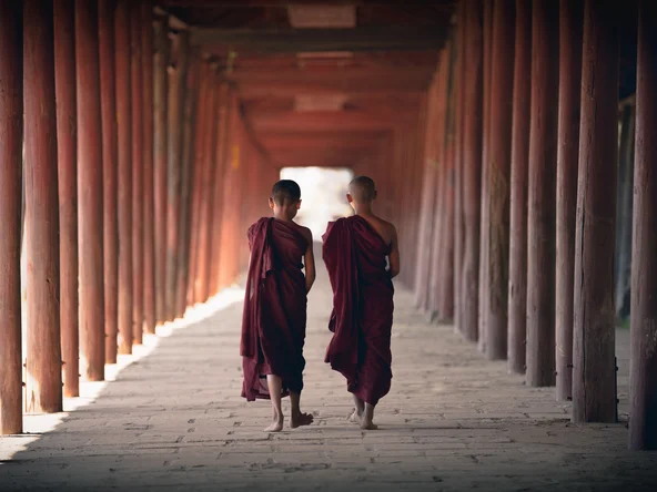 Monks walking under arches