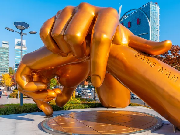 Sculpture of golden hands resting on each other as a Gangnam Style monument in Seoul 
