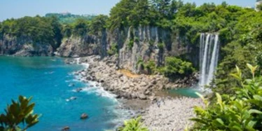 Waterfall by pebble beach in Jeju Island in South Korea 