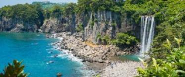 Waterfall by pebble beach in Jeju Island in South Korea 