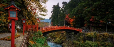 Ornate red bridge over river in Nikko 