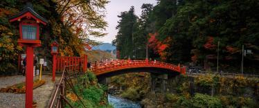 Ornate red bridge over river in Nikko 