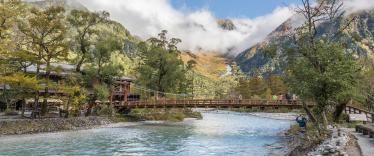 Bridge over fast flowing river in Kamikochi 