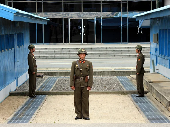 Three soldiers standing guard at the DMZ in Korea 