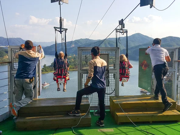 Two people strapped in and about to start the zip line at Nami Island 