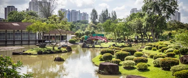 Red bridge over ornamental lake in Chinese and Japanese Gardens in Singapore 