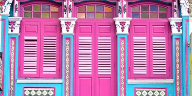 Bright pink doors and colourful trim on Peranakan building in Singapore 