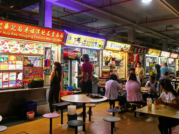 People queuing at food stalls in Singapore Hawker Centre 