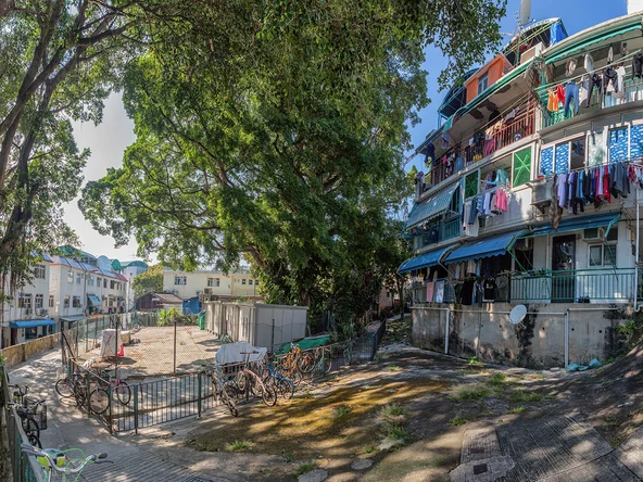 Colourful buildings with washing hanging and bicycle propped up outside 