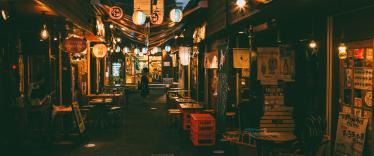 Japanese food stalls and outdoor seating at night 