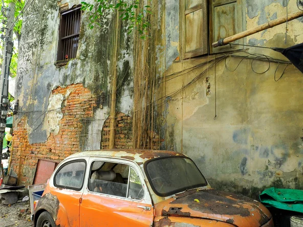 Orange vintage car street art on wall in Talad Noi, Bangkok 