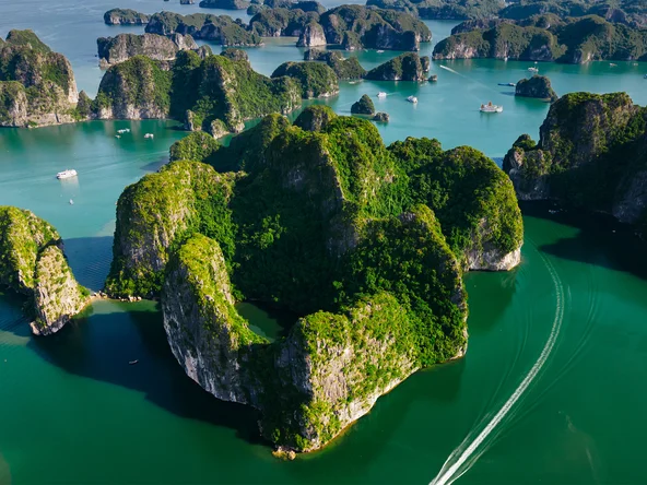 Aerial shot of the fascinating karst rock formations in Lan Ha Bay, with cruise ships in view